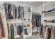 Spacious walk-in closet featuring custom shelving and ample hanging space for organized storage at 5521 Erinvale Ct, Holly Springs, NC 27540