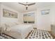 Serene bedroom with plush bedding, neutral color palette, and a ceiling fan at 607 N Queen St, Durham, NC 27701