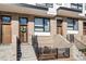 Modern townhouse with brick facade, stylish wood doors, and manicured landscaping, offering an inviting curb appeal at 607 N Queen St, Durham, NC 27701