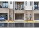 Townhome with a garage, complemented by neutral brick accents and a cozy balcony above at 607 N Queen St, Durham, NC 27701