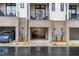 View of the garages in the modern townhome with brick and white siding with 2nd story balconies at 607 N Queen St, Durham, NC 27701
