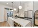 Contemporary kitchen with island, stainless steel appliances, and access to a balcony at 607 N Queen St, Durham, NC 27701