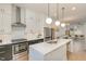 Modern kitchen with stainless steel appliances, quartz countertops, and a spacious island at 607 N Queen St, Durham, NC 27701