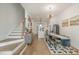 Open living space featuring hardwood floors, modern decor, with a staircase and adjacent kitchen at 607 N Queen St, Durham, NC 27701