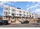 Modern townhomes with gray and white exteriors, brick accents, and well-manicured landscaping at 607 N Queen St, Durham, NC 27701