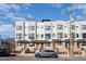 Contemporary townhomes feature brick facades and a gray exterior trim for a modern look at 607 N Queen St, Durham, NC 27701