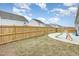 Fenced backyard featuring a grassy area, a concrete patio, and play equipment at 733 Frosty Way, Zebulon, NC 27597
