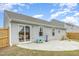Backyard showcasing a gray home exterior, a concrete patio, some grass and a wooden fence at 733 Frosty Way, Zebulon, NC 27597