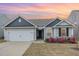 Charming single Gathering home showcasing a manicured lawn and attached two car garage at 733 Frosty Way, Zebulon, NC 27597