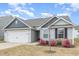 Charming single Gathering home showcasing a manicured lawn and attached two car garage at 733 Frosty Way, Zebulon, NC 27597