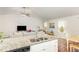 Eat-in kitchen with stainless steel appliances, granite countertops, and living room access at 733 Frosty Way, Zebulon, NC 27597