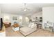 Open concept living room features a modern ceiling fan and flows into the kitchen at 733 Frosty Way, Zebulon, NC 27597