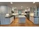 Modern kitchen with white cabinets, stainless steel appliances, and a center island at 737 Crabtree Crossing Pkwy, Cary, NC 27513