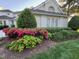 Charming home exterior with vibrant landscaping and manicured bushes, adding curb appeal at 737 Crabtree Crossing Pkwy, Cary, NC 27513