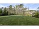 Spacious, well-maintained backyard lawn with trees and a fenced property line at 8117 Fergus Ct, Wake Forest, NC 27587