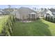 Expansive backyard with lush green grass, a patio with a fire pit, outdoor seating, and a screened porch at 8117 Fergus Ct, Wake Forest, NC 27587