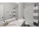 Bright bathroom featuring double vanity with granite countertop and shower-tub combination at 8117 Fergus Ct, Wake Forest, NC 27587