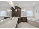 Bright bathroom showing double vanity with stone countertop, cabinets, and separate tub and shower at 8117 Fergus Ct, Wake Forest, NC 27587