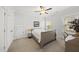 Bright bedroom with carpeted floors, ceiling fan, two windows and a closet at 8117 Fergus Ct, Wake Forest, NC 27587