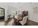 Formal dining room with coffered ceilings, elegant chandelier, and dark hardwood flooring at 8117 Fergus Ct, Wake Forest, NC 27587
