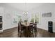 Dining room with wood table, chairs, natural light, and modern chandelier at 8117 Fergus Ct, Wake Forest, NC 27587