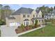 Beautiful brick home with a three-car garage, lush landscaping, and covered front porch at 8117 Fergus Ct, Wake Forest, NC 27587
