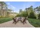 Paver patio with Adirondack chairs surrounding a fire pit, perfect for outdoor entertaining in a serene backyard setting at 8117 Fergus Ct, Wake Forest, NC 27587