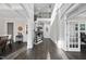 Grand foyer showcasing dark hardwood floors, a staircase with iron railings, and ample natural light at 8117 Fergus Ct, Wake Forest, NC 27587