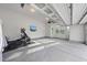 Clean and organized garage space with epoxy flooring and an exercise machine at 8117 Fergus Ct, Wake Forest, NC 27587