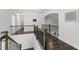 Upstairs hallway with dark wood floors, white walls, and iron railing at 8117 Fergus Ct, Wake Forest, NC 27587