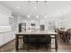 Bright kitchen with a granite island with seating, stainless steel appliances, and white cabinetry at 8117 Fergus Ct, Wake Forest, NC 27587