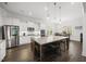 Bright kitchen with a granite island with seating, stainless steel appliances, and white cabinetry at 8117 Fergus Ct, Wake Forest, NC 27587