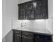 Kitchenette with granite countertops, dark wood cabinets, and wine cooler at 8117 Fergus Ct, Wake Forest, NC 27587