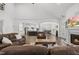 Spacious living room featuring hardwood floors, a fireplace, and an open layout to the kitchen at 8117 Fergus Ct, Wake Forest, NC 27587