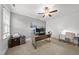 Spacious office with a large desk, fan, two additional desks, carpet, and a window providing natural light at 8117 Fergus Ct, Wake Forest, NC 27587