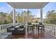 Inviting screened porch with outdoor seating, a table, and views of the surrounding nature at 8117 Fergus Ct, Wake Forest, NC 27587