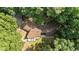 Aerial view of the property showcasing the unique roofline and surrounding mature trees at 8805 Leesville Rd, Raleigh, NC 27613