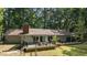 Exterior elevation of home with expansive back deck, multiple seating areas, and mature trees at 8805 Leesville Rd, Raleigh, NC 27613