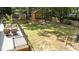Backyard featuring a patio, fire pit, and storage shed in a wooded, private setting at 8805 Leesville Rd, Raleigh, NC 27613
