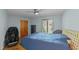 Comfortable bedroom with hardwood floors, ceiling fan, and a window overlooking the exterior at 8805 Leesville Rd, Raleigh, NC 27613