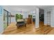 Dining area with hardwood floors, a bench seat, and large mirror wall at 8805 Leesville Rd, Raleigh, NC 27613