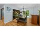 Bright dining room featuring hardwood floors, a modern chandelier and sliding door access to the outdoor space at 8805 Leesville Rd, Raleigh, NC 27613