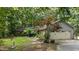 Ranch home featuring a stone facade, attached garage and mature landscaping at 8805 Leesville Rd, Raleigh, NC 27613