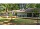 Home's rear exterior showcasing a large deck with railings and sliding glass doors at 8805 Leesville Rd, Raleigh, NC 27613