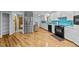 Spacious kitchen with white cabinets, stainless steel appliances, and a beautiful blue tile backsplash at 8805 Leesville Rd, Raleigh, NC 27613