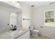 Bright bathroom featuring a single vanity with granite countertop and a toilet at 8917 Fowler Rd, Zebulon, NC 27597