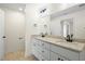 Bright bathroom featuring double vanity with granite countertop, mirror, and modern fixtures at 8917 Fowler Rd, Zebulon, NC 27597