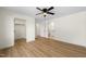 Bedroom with wood-look flooring with doors to a closet and bathroom at 8917 Fowler Rd, Zebulon, NC 27597