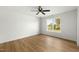Bedroom with wood-look flooring, a ceiling fan, and view of the backyard at 8917 Fowler Rd, Zebulon, NC 27597