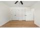 Bedroom with wood-look flooring and two large closets with white doors and black hardware at 8917 Fowler Rd, Zebulon, NC 27597